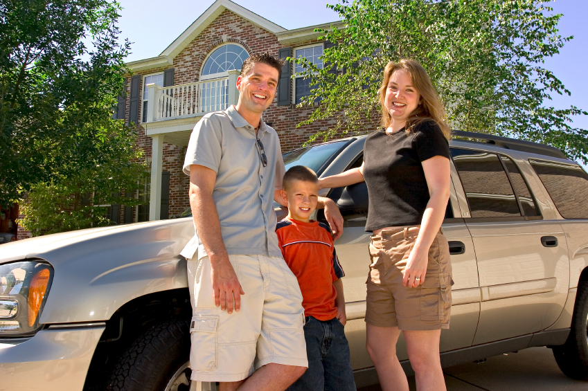 family in front of house